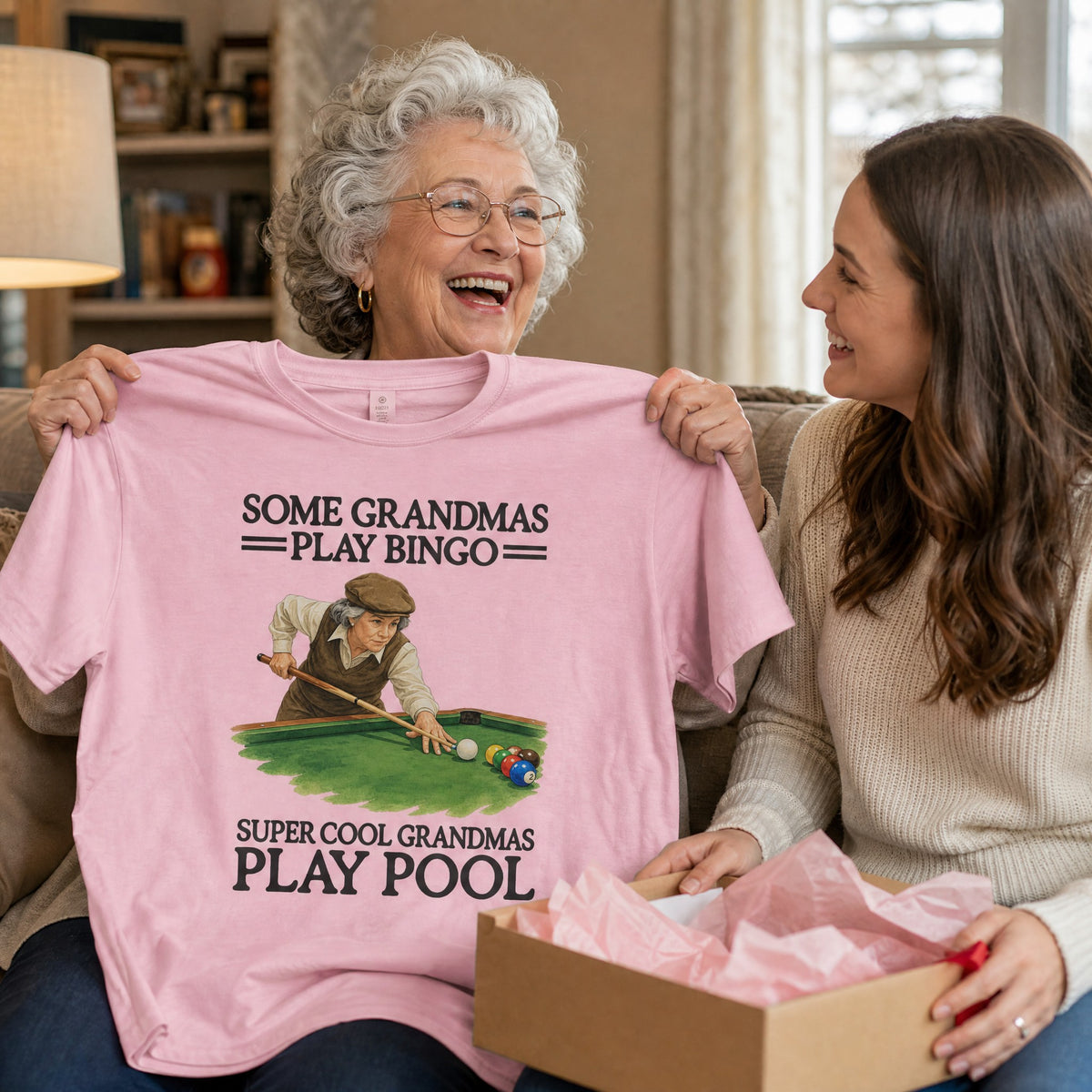 Grandma laughing as she opens the Super Cool Grandmas Play Pool tee in Blossom as a gift
